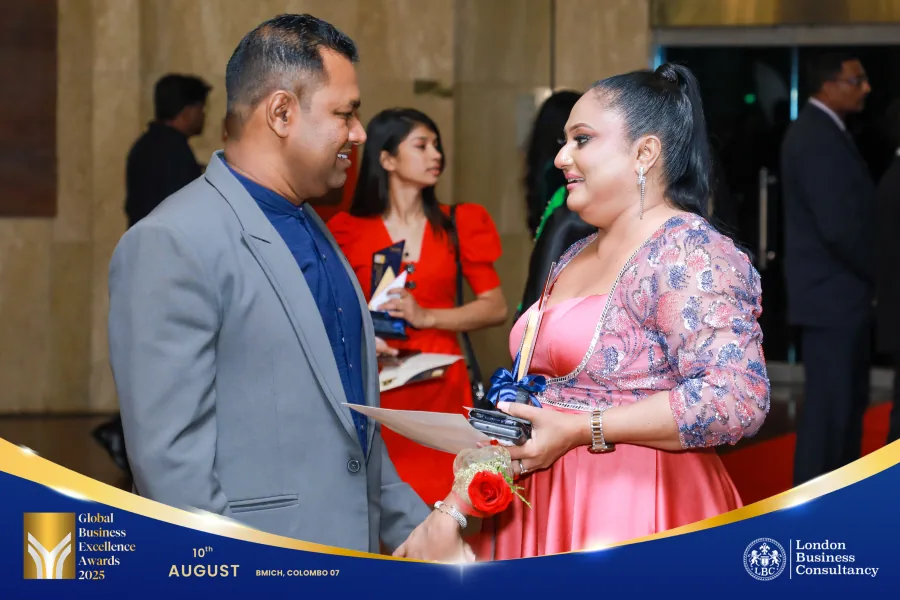 An award recipient speaking with a guest during the GBE Awards event