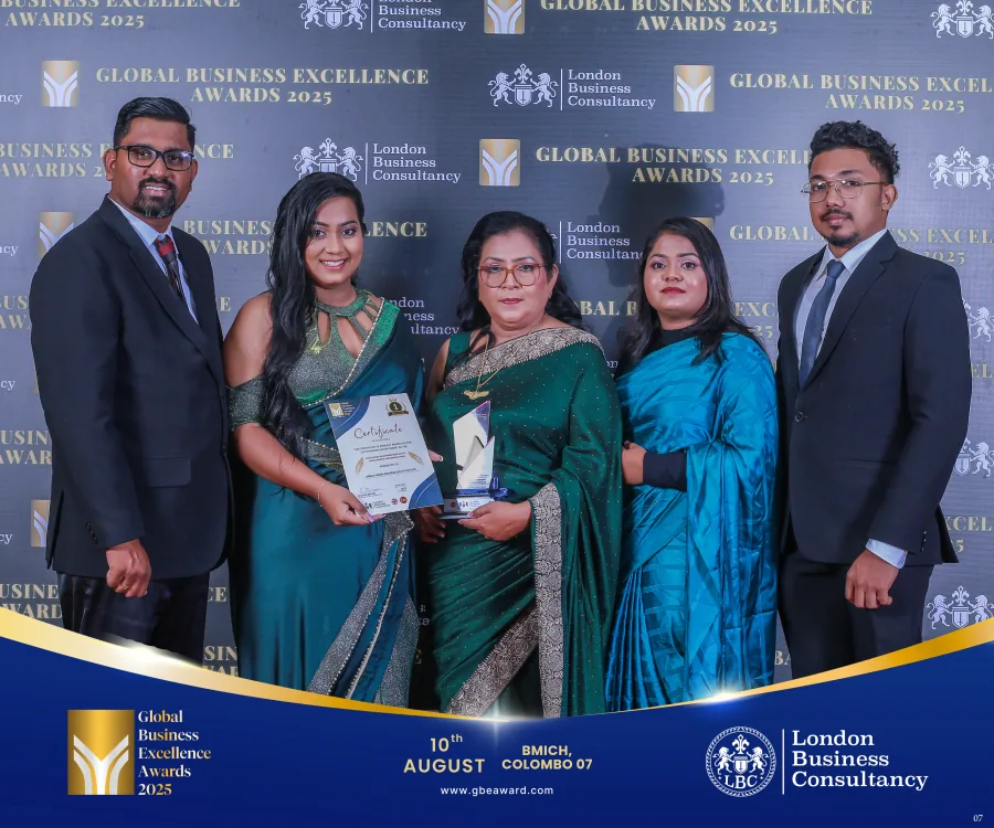 Women pictured with a GBE Awards recipient, certificate and trophy